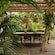 A shaded outdoor dining area with a table for 6